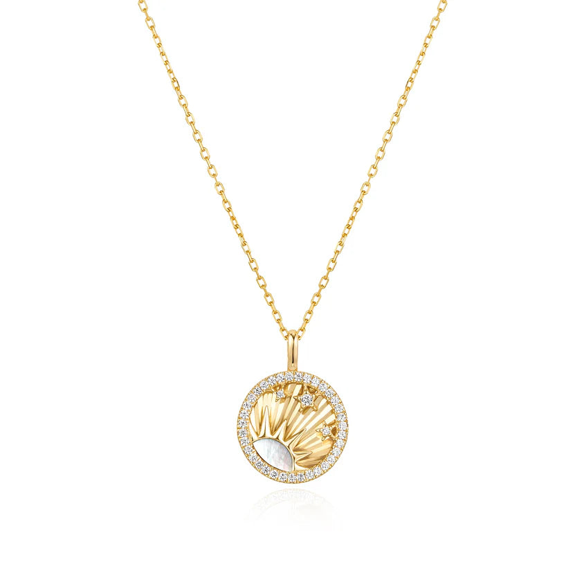 Gold necklace with a circular pendant on a white background