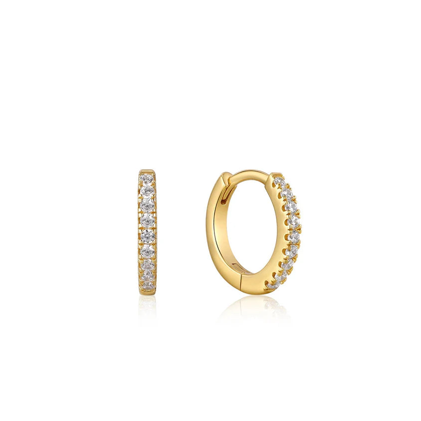 Gold hoop earrings with embedded diamonds on a white background