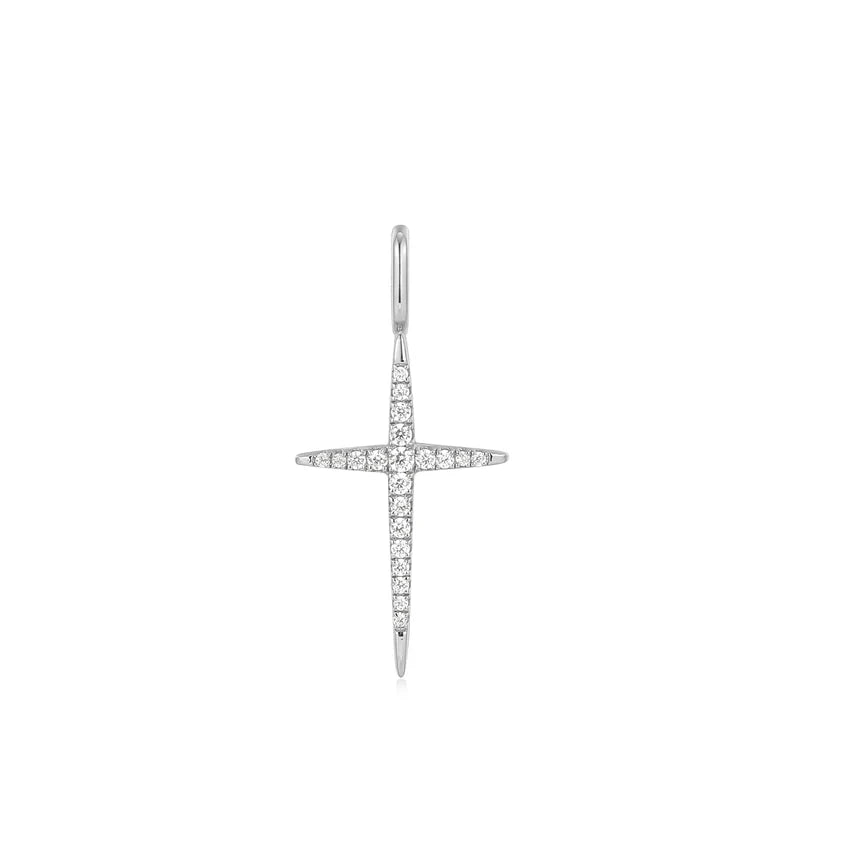 Silver cross-shaped earring with clear stones on a white background