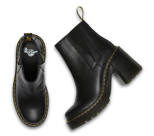 A pair of black Dr Martens Spence leather boots with a grooved outsole and flared heel, featuring a smooth full-grain finish.
